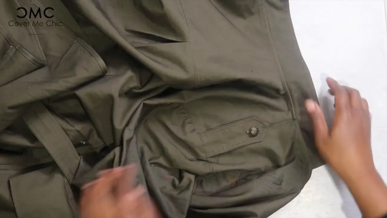 Sewing buttons onto the shoulder tabs of the maxi wrap dress